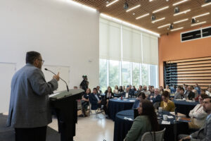 Presenter speaking to a room of higher education professionals
